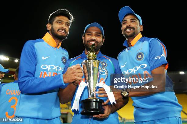 Khaleel Ahmed, Rohit Sharma and Mohammed Siraj of India hold the series trophy after winning game five in the One Day International series between...