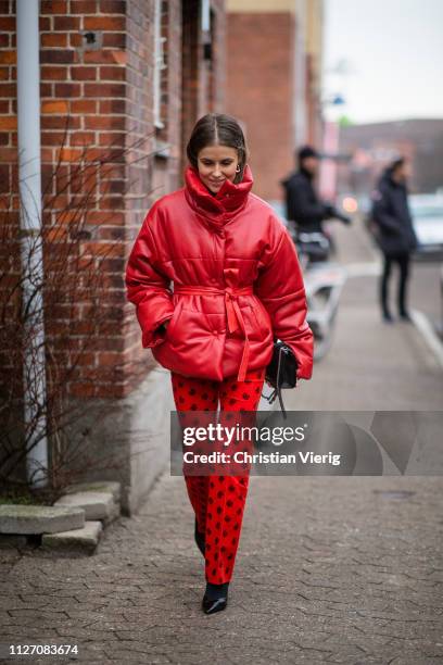 Nina Sandbech is seen wearing red coat, pants with print outside Baum und Pferdgarten during the Copenhagen Fashion Week Autumn/Winter 2019 - Day 3...