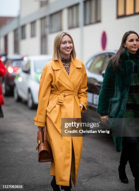 Lisa Aiken is seen wearing yellow coat, brown bag outside Baum und Pferdgarten during the Copenhagen Fashion Week Autumn/Winter 2019 - Day 3 on...