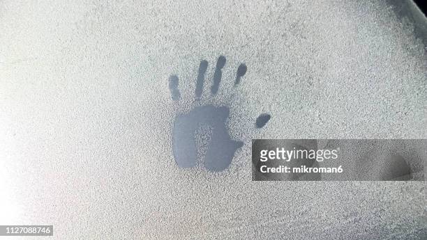 close-up of handprint on frozen car windshield - human hand drawing stock pictures, royalty-free photos & images