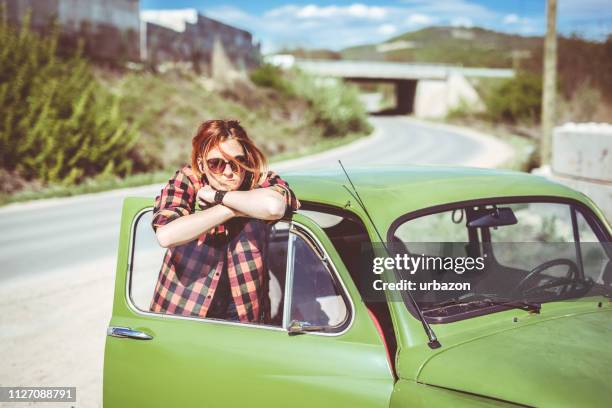 redhead girl leaning on car door - car top down stock pictures, royalty-free photos & images