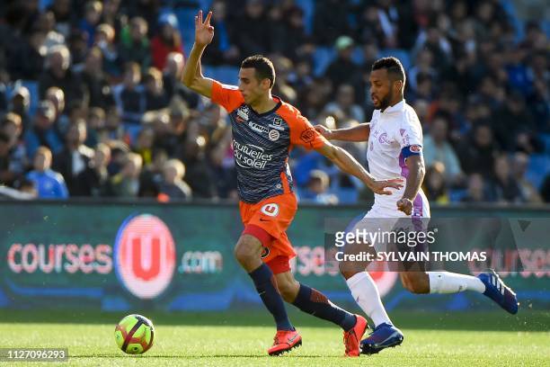 Montpellier's Tunisian defender Ellyes Skhiri vies with Reim's French defender Jacques Romao during the French L1 football match between Montpellier...