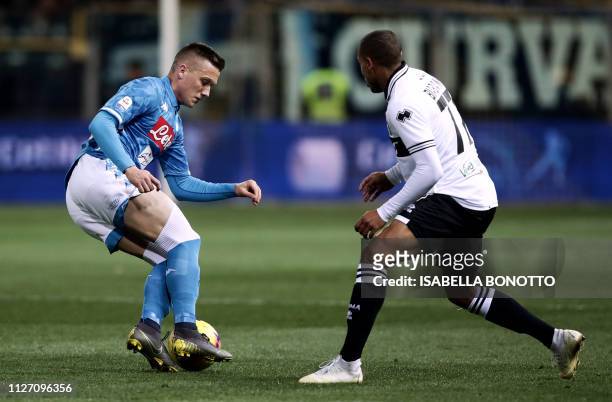 Napoli's Polish midfielder Piotr Zielinski vies for the ball with Parma's French forward Jonathan Biabiany during the Italian Serie A football match...
