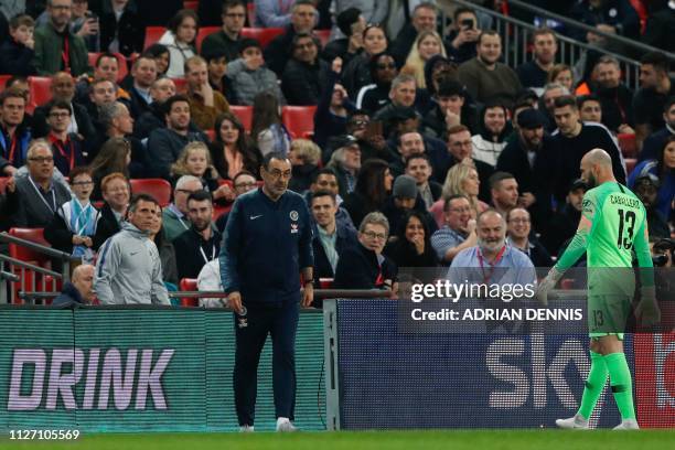 Chelsea's Italian head coach Maurizio Sarri reacts after Chelsea's Spanish goalkeeper Kepa Arrizabalaga remains on the pitch after an attempt to...