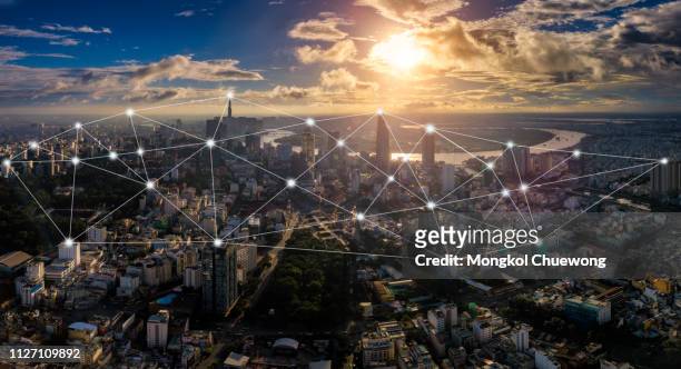cityscape of ho chi minh city in vietnam and network connection concept , network in center of heart business district near saigon river - global media stock pictures, royalty-free photos & images