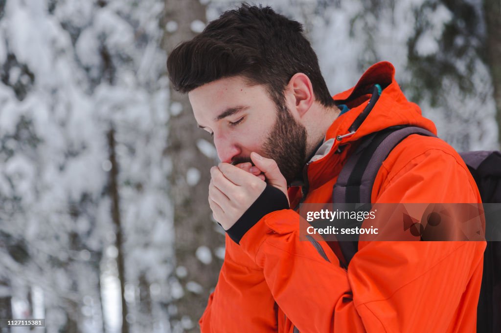 Man warming hands in winter time