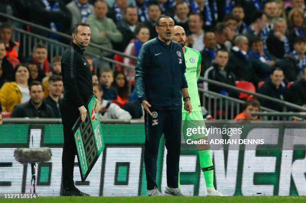 Chelsea's Italian head coach Maurizio Sarri reacts after Chelsea's Spanish goalkeeper Kepa Arrizabalaga remains on the pitch after an attempt to...