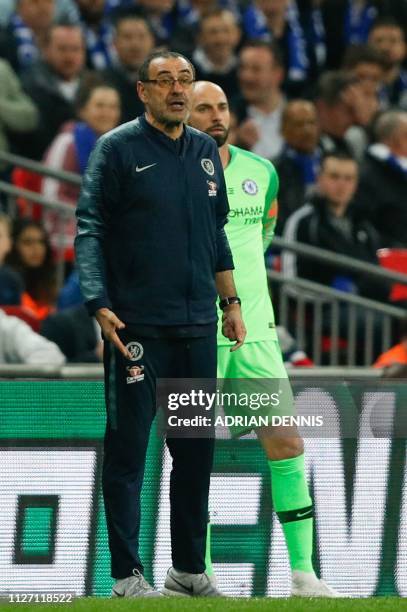 Chelsea's Italian head coach Maurizio Sarri reacts after Chelsea's Spanish goalkeeper Kepa Arrizabalaga remains on the pitch after an attempt to...