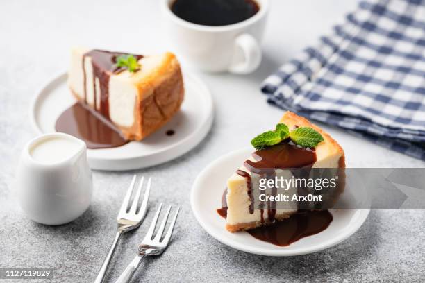 cheesecake with chocolate sauce and cup of coffee - cheesecake white stockfoto's en -beelden