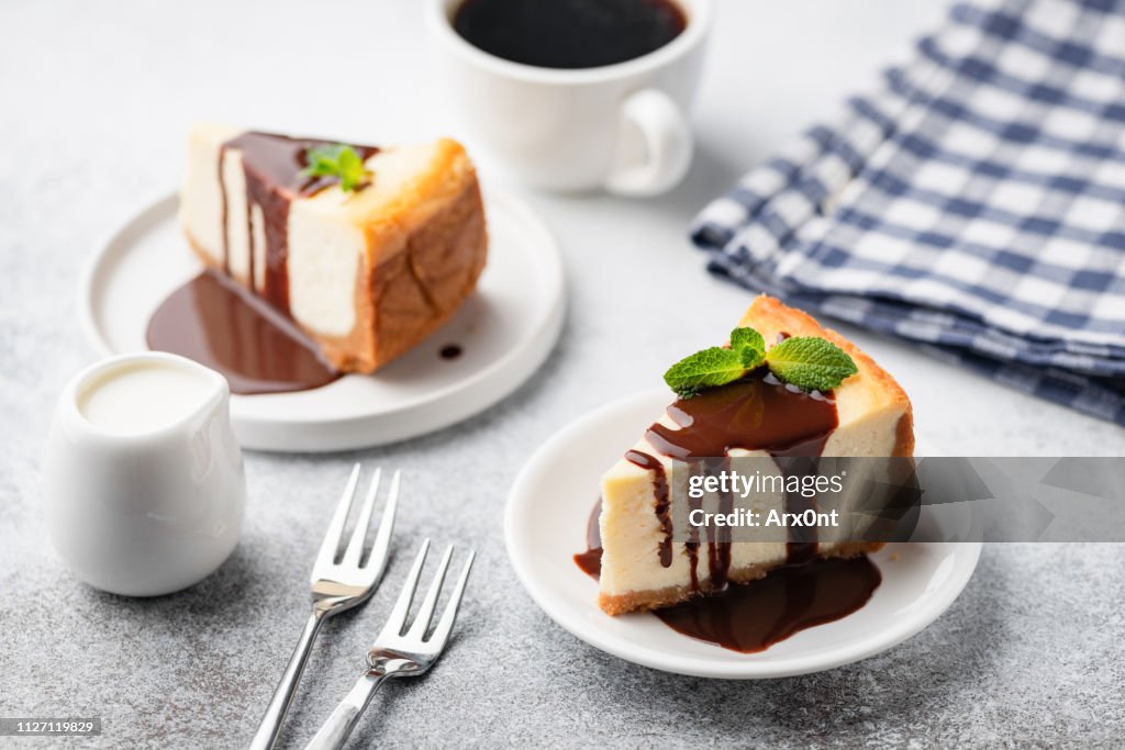 Cheesecake with chocolate sauce and cup of coffee