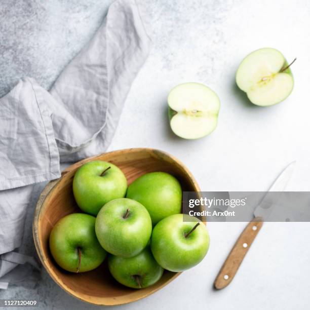 fresh green apples on concrete backdrop - green apples stock pictures, royalty-free photos & images