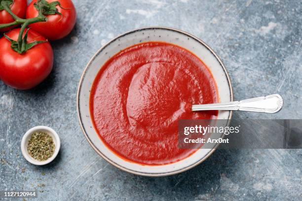 tomato soup or tomato passata in bowl - tomatensaus stockfoto's en -beelden