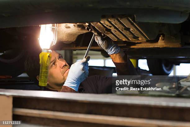 mechanic opens engine under car - baby boomer working stock pictures, royalty-free photos & images