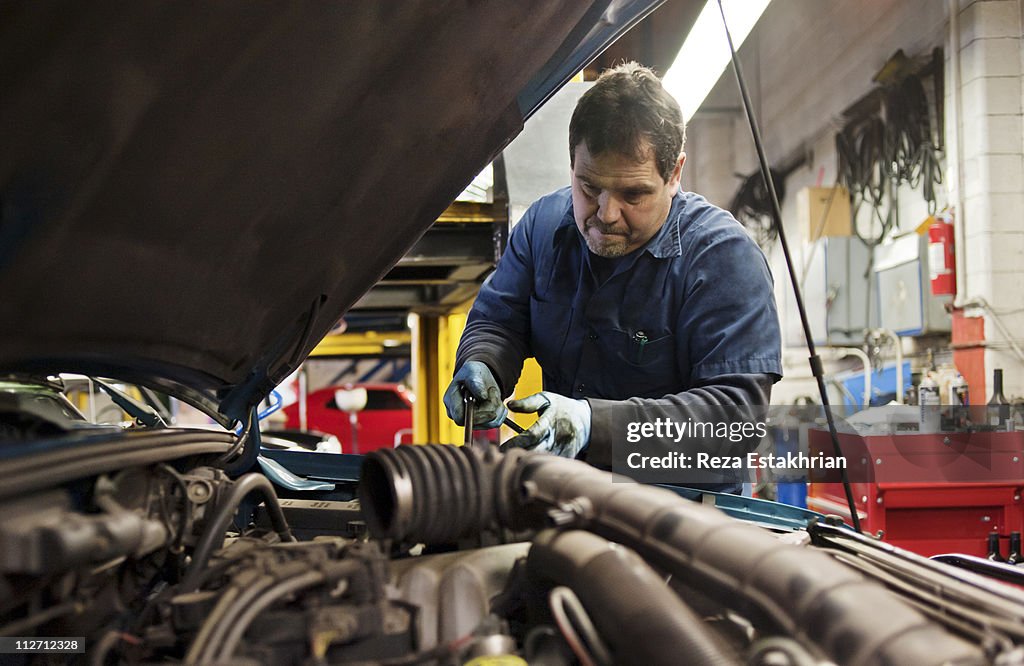 Mechanic fixes engine