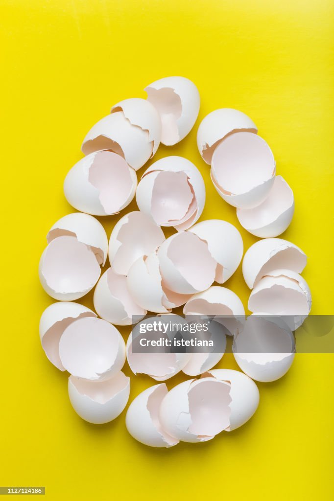 Egg shape with broken white eggs, new life fragility, chaotic arrangement