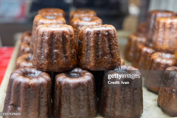 stack of caneles - paris food stock pictures, royalty-free photos & images