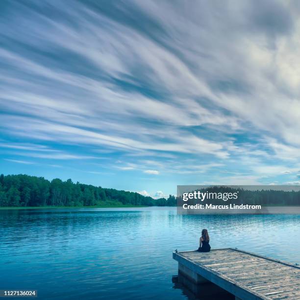 alone by the lake - woman pier stock pictures, royalty-free photos & images