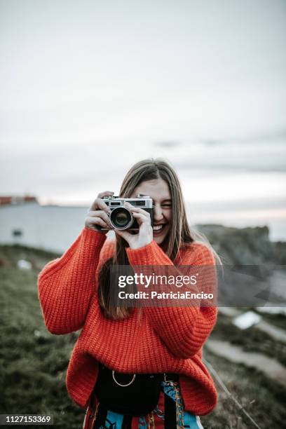 young woman using a vintage camera - photography themes stock pictures, royalty-free photos & images