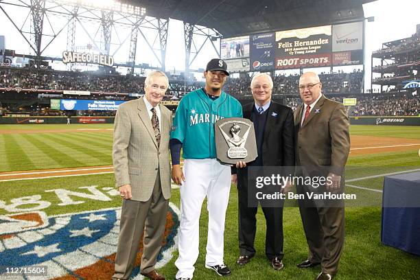 Starting pitcher Felix Hernandez of the Seattle Mariners receives his American League Cy Young Award prior to the Mariners home opener against the...