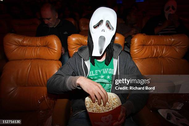 Fan poses with a Scream mask during the Scream 4 Paris Premiere at Le Grand Rex on April 12, 2011 in Paris, France.