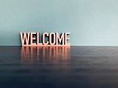 Word welcome on blue background