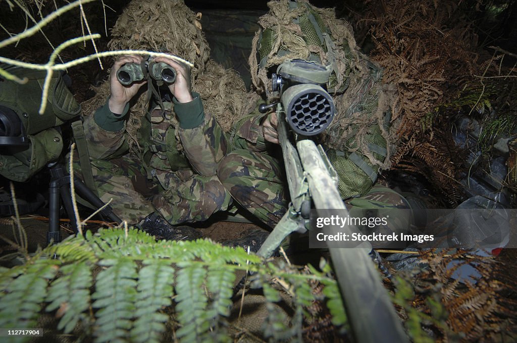 A British Army sniper team dressed in ghillie suits.