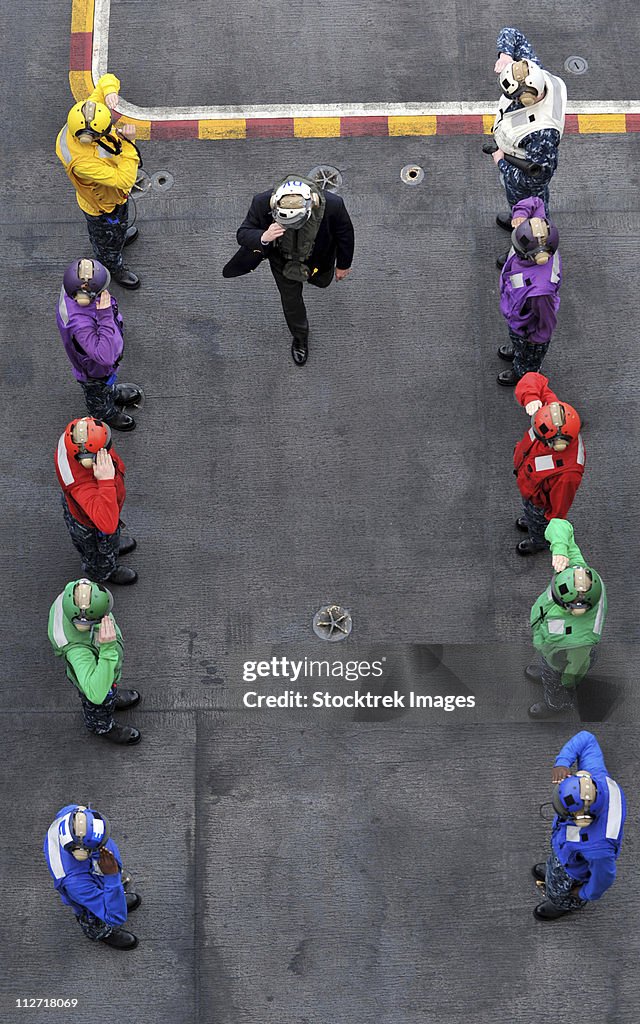 U.S. Navy rainbow sideboys stationed aboard aircraft carrier USS Abraham Lincoln.