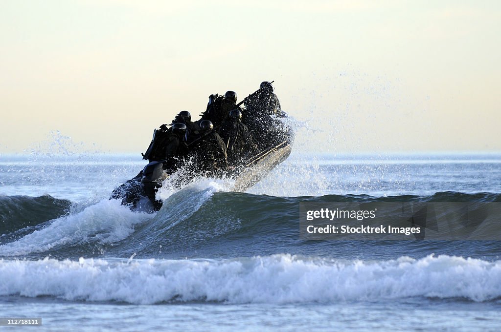 Students in Navy SEALs qualification training navigate the surf off the cost of Coronado.