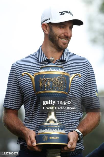 Dustin Johnson of the United States poses with the trophy after winning the World Golf Championships-Mexico Championship at Club de Golf Chapultepec...