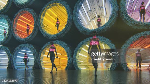 futuristic cyborgs walking in the city - neon tunnel stock pictures, royalty-free photos & images