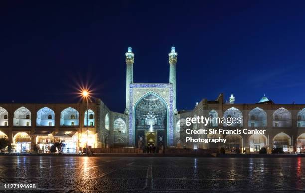 facade of "masjed-e shah" mosque ("shah mosque") illuminated at night on "naqsh-e jahan square" in isfahan, iran - mesquita emam - fotografias e filmes do acervo