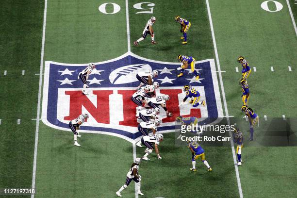 Tom Brady of the New England Patriots prepares to run the play against the Los Angeles Rams during the first quarter during Super Bowl LIII at...