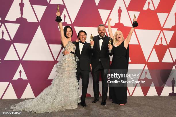 The producers of 'Free Solo', Elizabeth Chai Vasarhelyi, Jimmy Chin, Evan Hayes and Shannon Dill pose with the award for Best Documentary Feature in...