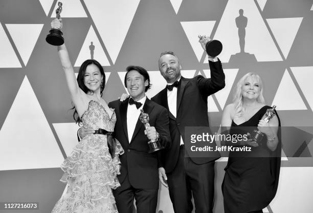 The producers of "Free Solo", Elizabeth Chai Vasarhelyi, Jimmy Chin, Evan Hayes and Shannon Dill pose with the award for Best Documentary Feature in...