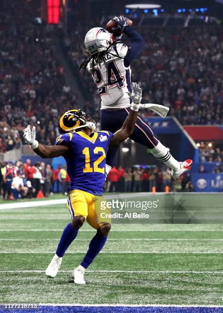 Stephon Gilmore of the New England Patriots catches a fourth quarter interception on a pass intended for Brandin Cooks of the Los Angeles Rams during...