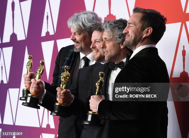 Best Visual Effects winners for "First Man" Ian Hunter , Paul Lambert , Tristan Myles and J.D. Schwalm pose in the press room with their Oscars...