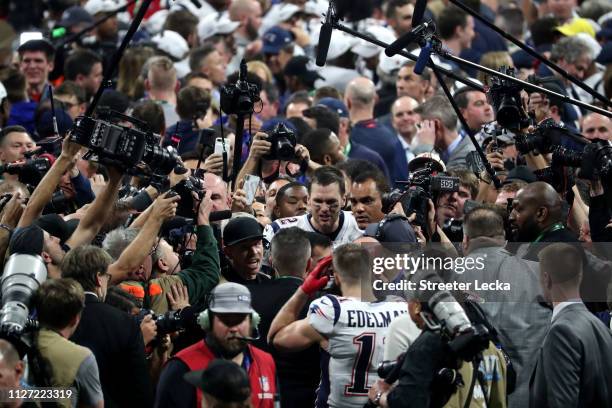 Photographers surround Tom Brady of the New England Patriots after his 13-3 win over the Los Angeles Rams in Super Bowl LIII at Mercedes-Benz Stadium...