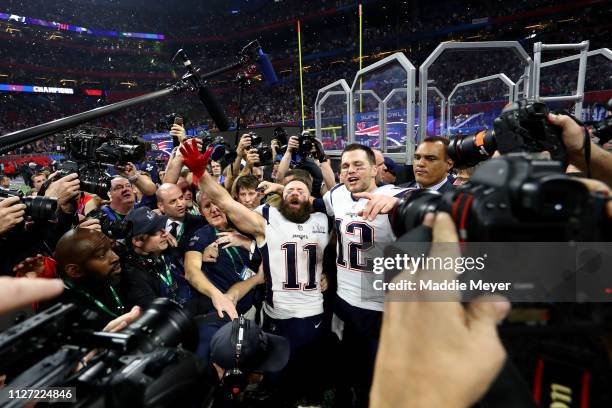 Tom Brady of the New England Patriots and Julian Edelman celebrate their teams 13-3 win over the Los Angeles Rams during Super Bowl LIII at...