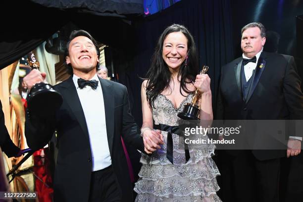 In this handout provided by A.M.P.A.S., Free Solo filmmakers Jimmy Chin and Elizabeth Chai Vasarhelyi pose with awards backstage during the 91st...