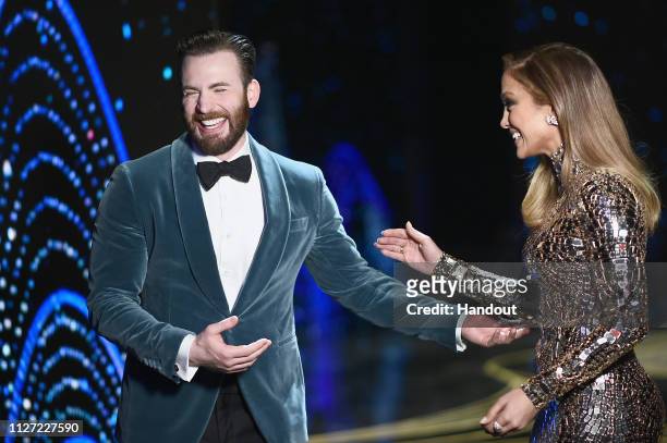 In this handout provided by A.M.P.A.S., presenters Chris Evans and Jennifer Lopez speak onstage during the 91st Annual Academy Awards at the Dolby...