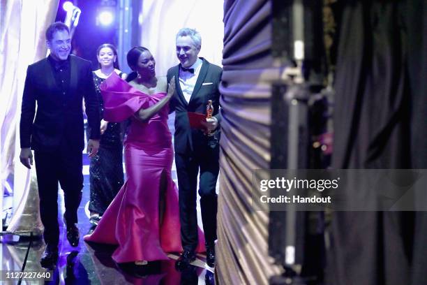 In this handout provided by A.M.P.A.S., presenter Angela Bassett poses with Foreign Language Film winner Alfonso Cuaron backstage during the 91st...