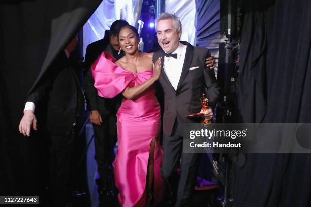 In this handout provided by A.M.P.A.S., presenter Angela Bassett poses with Foreign Language Film winner Alfonso Cuaron backstage during the 91st...