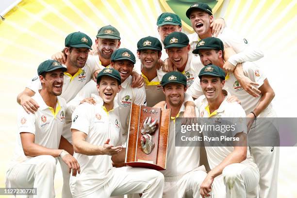 Australia celebrate with the trophy during day four of the Second Test match between Australia and Sri Lanka at Manuka Oval on February 04, 2019 in...