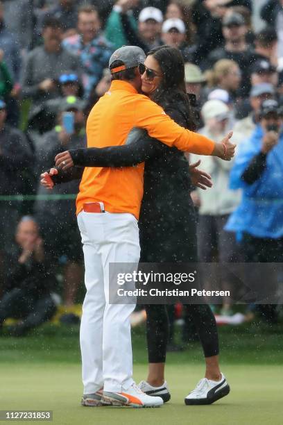 Rickie Fowler is met and congratulated by his fiancé Allison Stokke after winning in the final round of the Waste Management Phoenix Open on February...