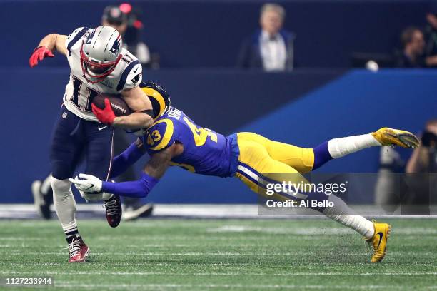 Julian Edelman of the New England Patriots runs the ball against John Johnson of the Los Angeles Rams in the fourth quarter during Super Bowl LIII at...