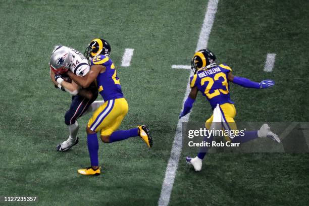 Rex Burkhead of the New England Patriots is tackled by Marcus Peters of the Los Angeles Rams in the second half during Super Bowl LIII at...