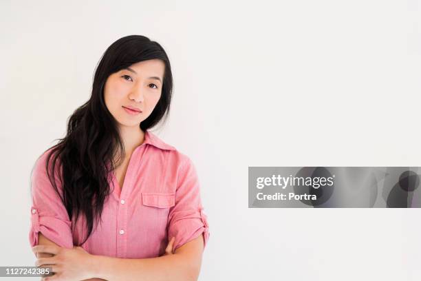 businesswoman with arms crossed over white - pink collared shirt stock pictures, royalty-free photos & images