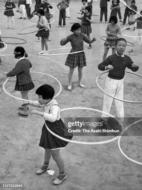 Children play with Hula hoops on November 12, 1958 in Osaka, Japan.