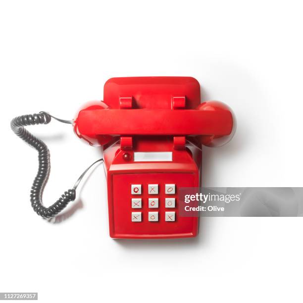 top shot of red vintage phone on white background with  keyboard like morpion game - morpion stock-fotos und bilder