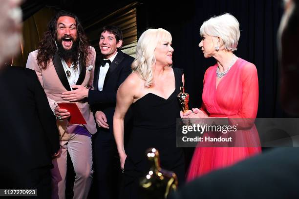 In this handout provided by A.M.P.A.S., Presenters Jason Momoa and Helen Mirren pose backstage with Alex Honnold and producer Shannon Dill after...